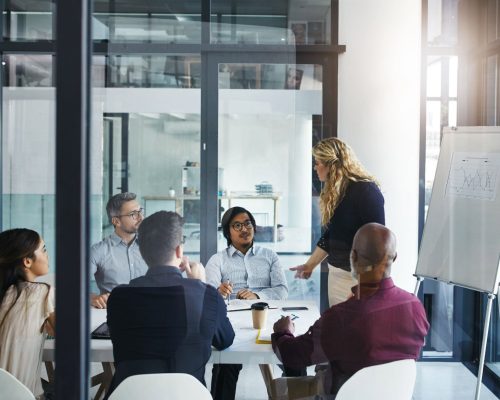 a group of people sitting around a table in an office